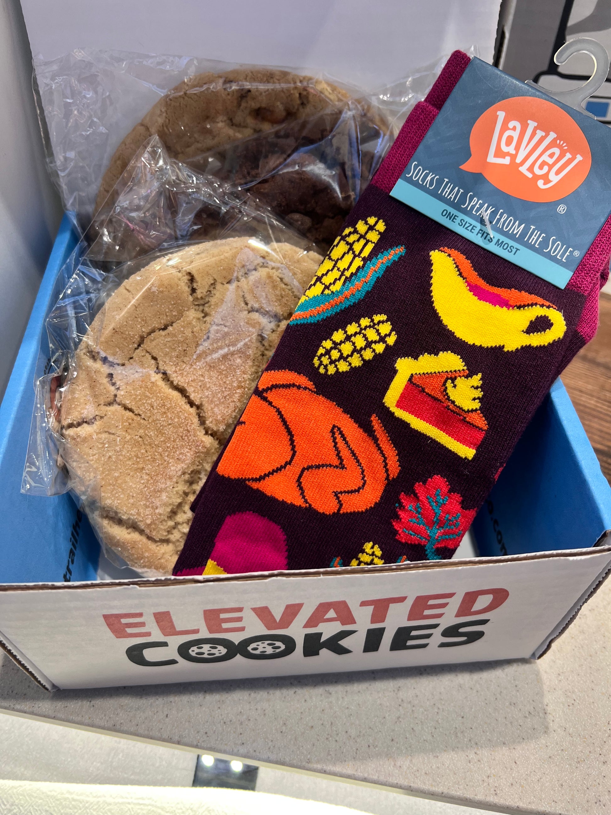 Colorful socks with corn and turkey design with on a gift box of with cookies large cookies