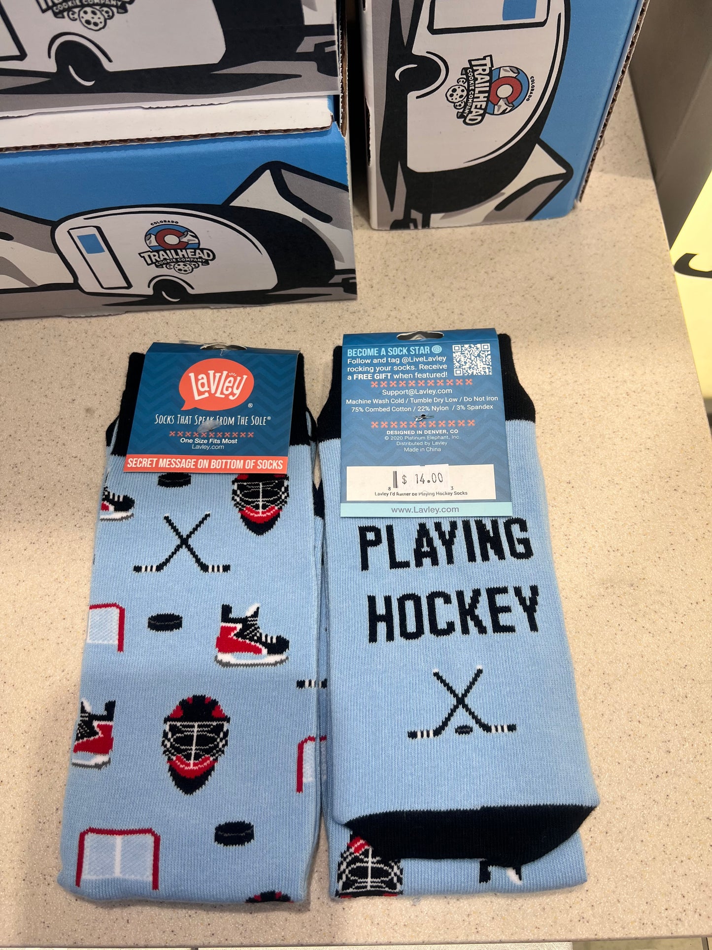 Hockey-themed socks with branding on a light surface with text "I'd rather be playing hockey"