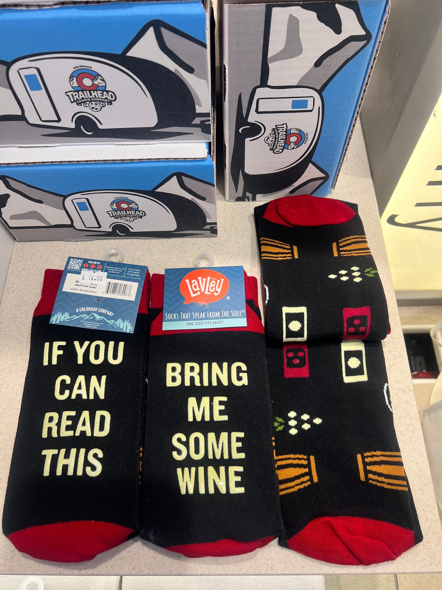 Black socks with humorous text and graphics 'if you can read this bring me some wine'