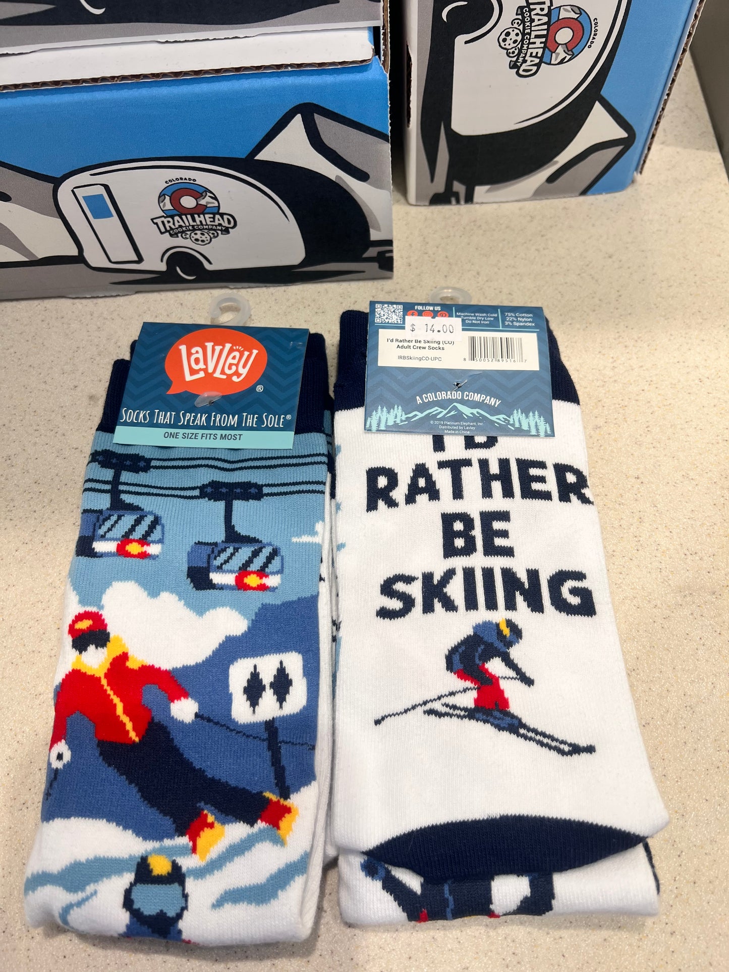 Pair of socks with skiing design, gondola and text, 'id rather be skiing'