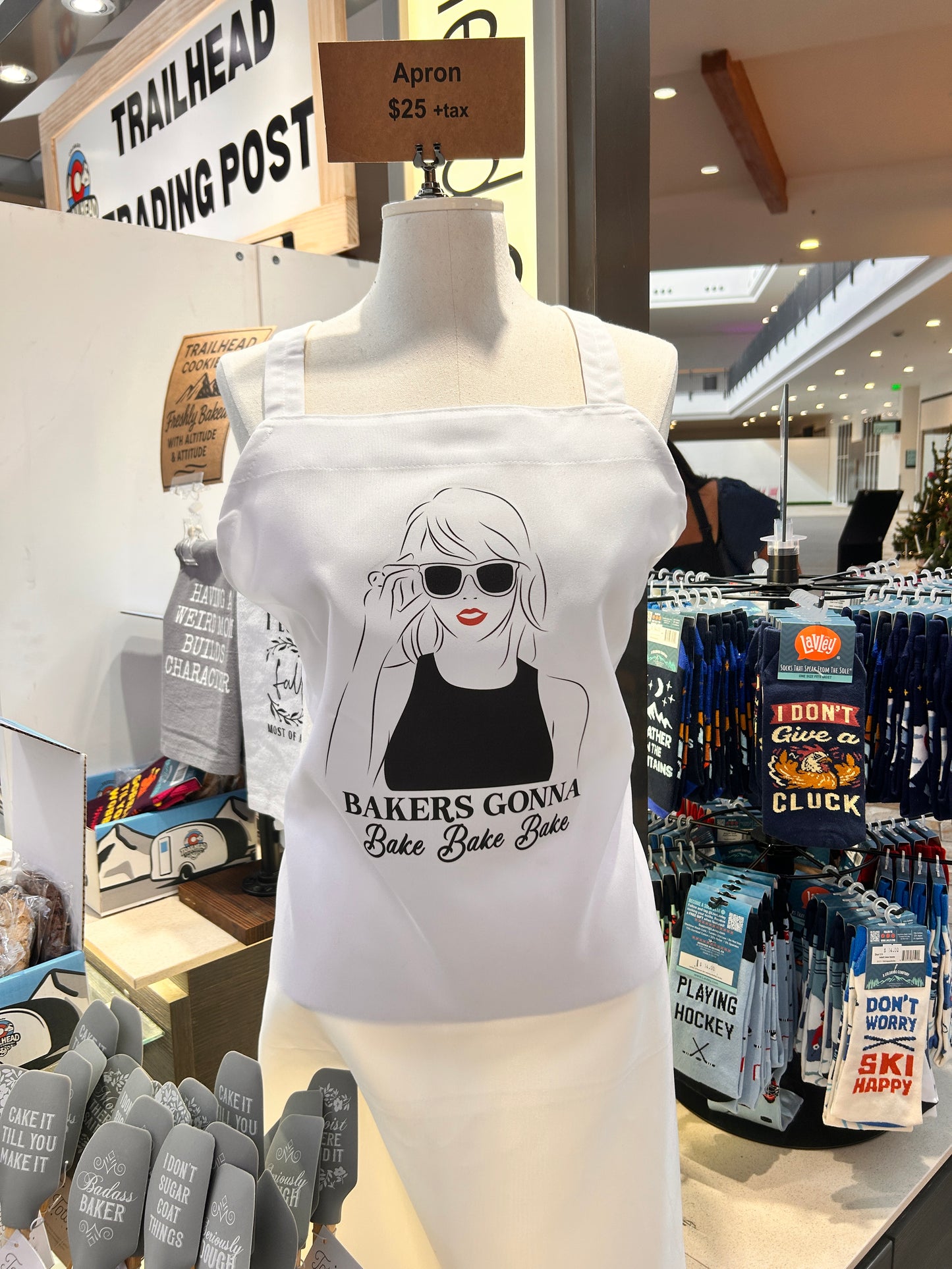 White Taylor inspired Apron with graphic design on a mannequin in a store setting