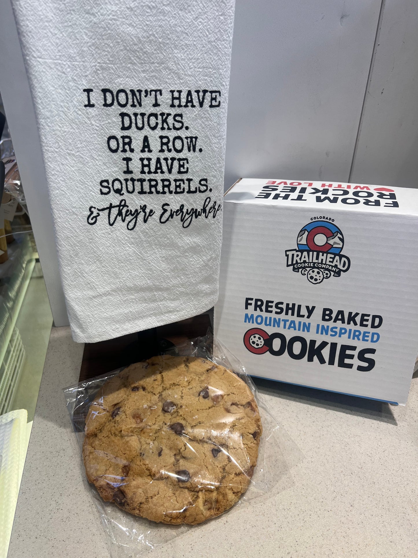 Trailhead cookies with a wrapped cookie and a towel with text