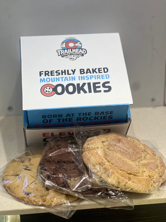 3 half pound fresh based Trailhead cookies with gift box packaging on a shelf